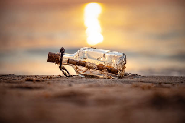 istock Message in the bottle against the Sun setting down 1348425468