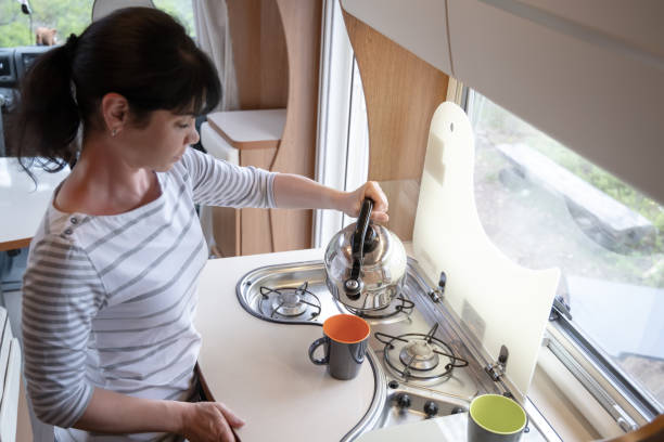 istock Woman cooking in camper, motorhome interior 1348425504