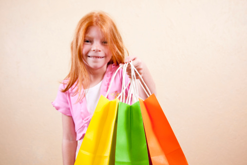 Little red haired girl with gift bags