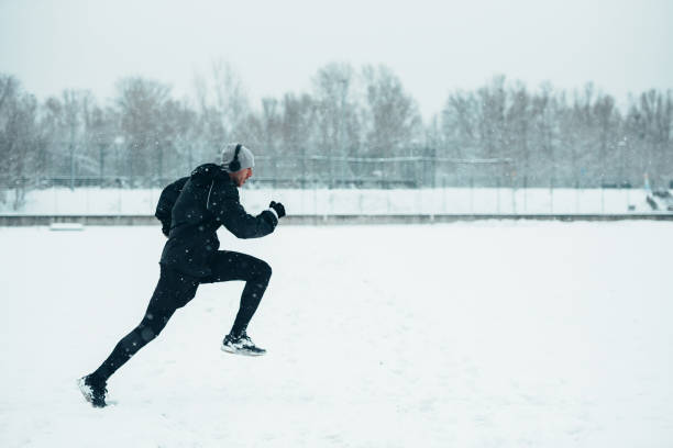 istock Handsome young man running and training on a cold winter day 1348437258