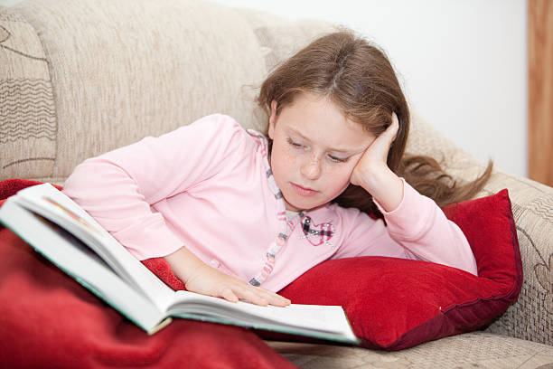 istock girl rest on sofa and reading the book 134845518