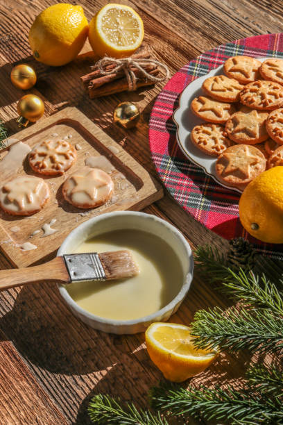 Baking christmas cookies with lemon frosting Baking christmas cookies with lemon frosting food styling stock pictures, royalty-free photos & images