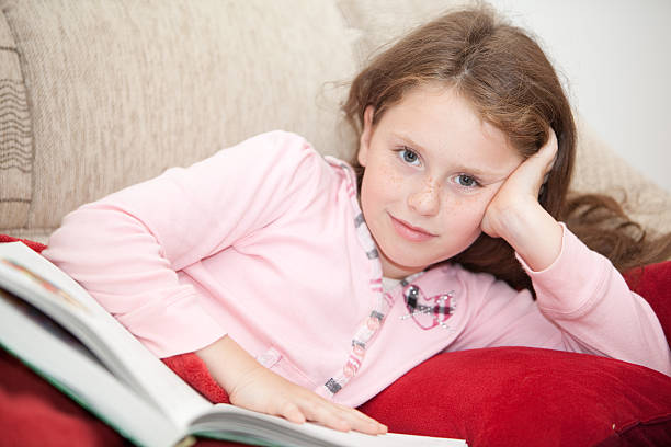 istock girl rest on sofa and reading the book 134846513