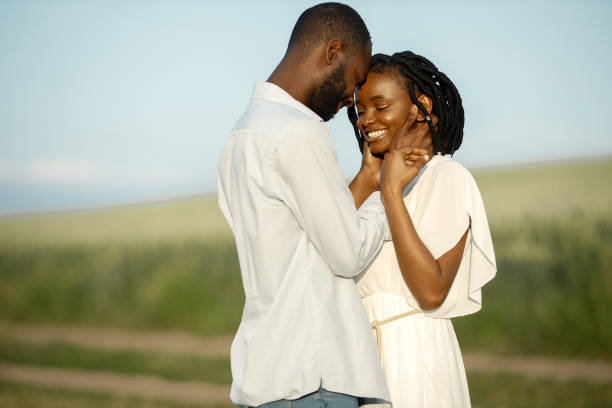 istock Happy romantic couple hugging in a summer field 1348477865