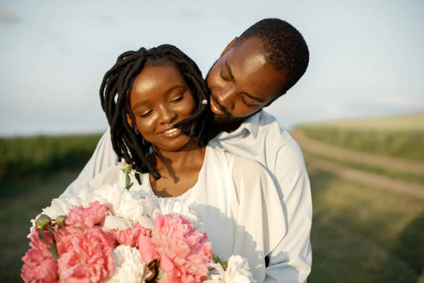 istock Happy romantic couple hugging in a summer field 1348477879