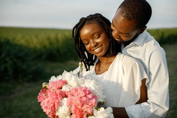 istock Happy romantic couple hugging in a summer field 1348477881