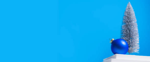 istock Christmas tree on a white podium on a blue background. Banner 1348483609