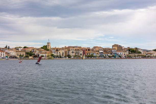 View in cloudy weather over the village of Bouzigues, on the edge of the Thau lagoon (Occitanie, France) stock photo