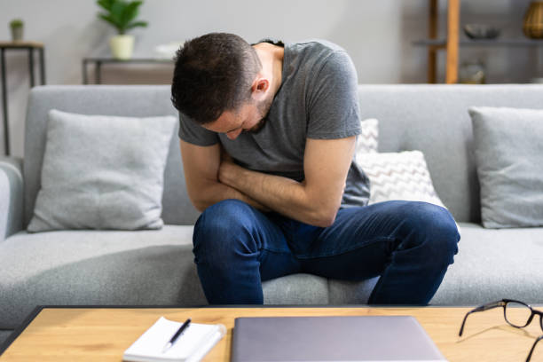istock Man Suffering From Stomach Ache Sitting 1348494832