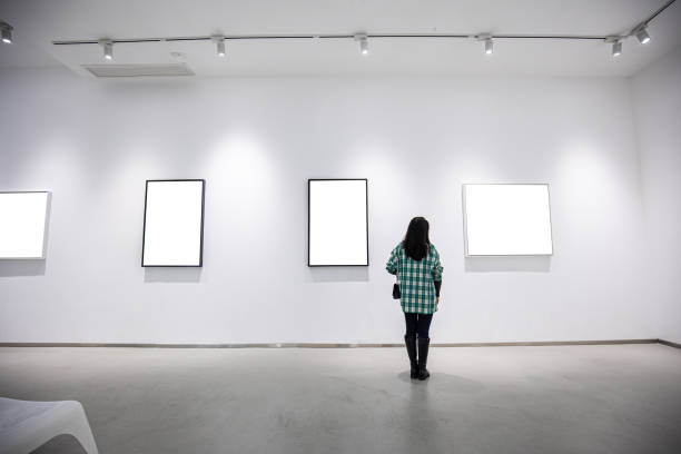 istock Young  woman looking at an art gallery 1348498418