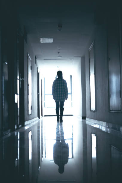 istock Young women walking in dark corridor 1348499609