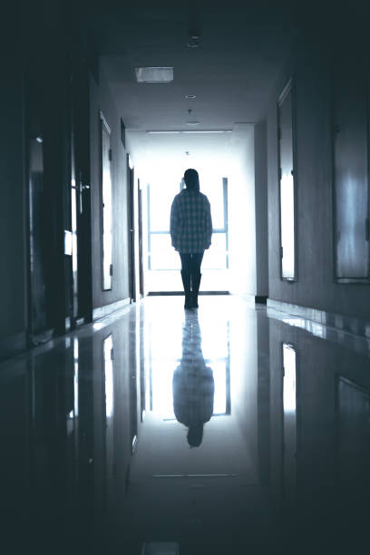 istock Young women walking in dark corridor 1348499657