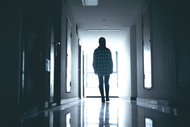 istock Young women walking in dark corridor 1348499664