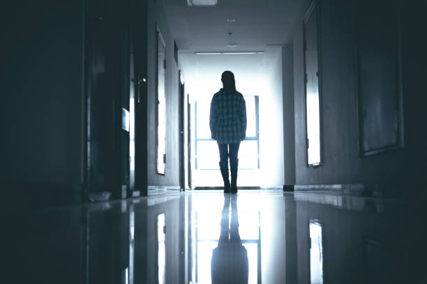 istock Young women walking in dark corridor 1348500172