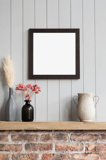 istock Artwork mock-up in interior design. Blank white picture frame on a gray wall 1348517030