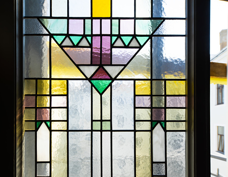 Stained glass window yellow with geometric linear patterns