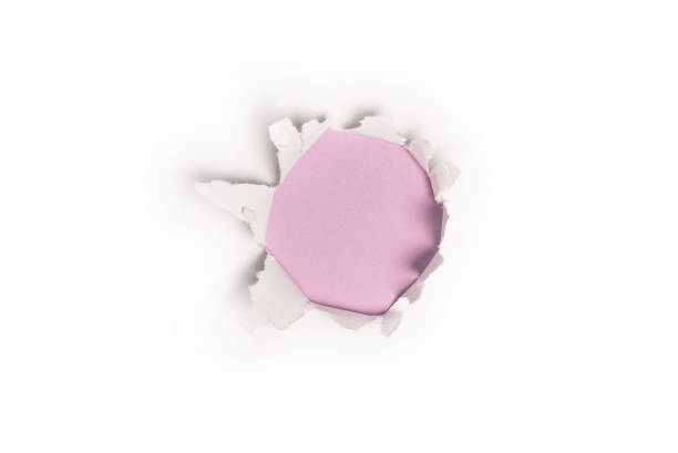 istock A hole in a white paper on a purple background. 1348522748