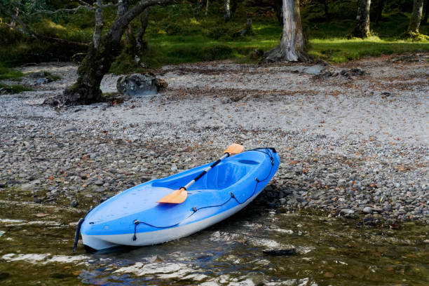 blue kayak in loch lomond on open water - loch rowboat lake landscape imagens e fotografias de stock