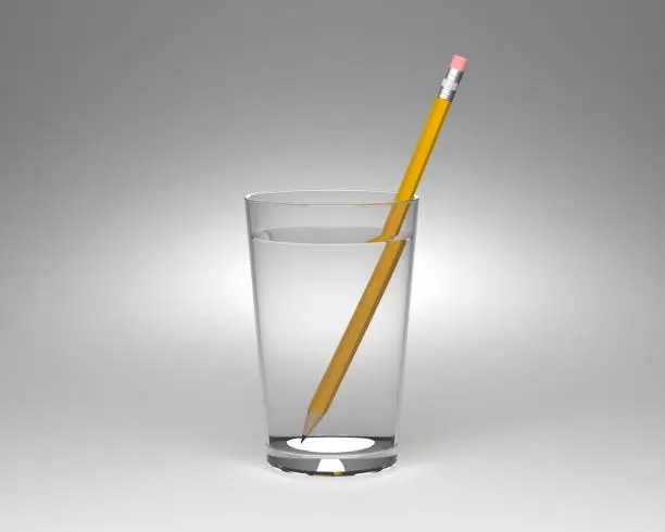 Light refraction experiment in a glass of water. Pencil and glass of water.