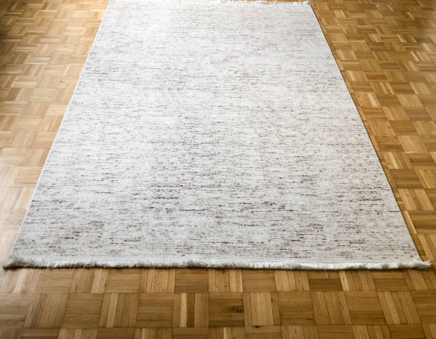 istock white carpet on parquet floor in the room 1348537800