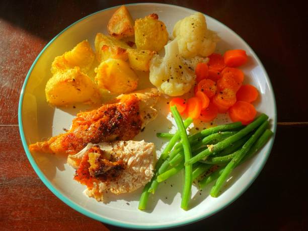 istock Sunlit Sunday roast chicken potatoes and vegetables 1348538437
