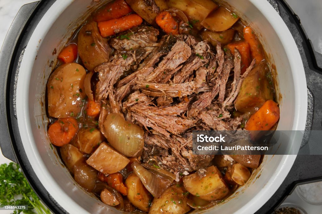 Slow Cooker Pot Roast Slow Cooker Pot Roast with Potatoes, Carrots, Celery, Onions and Garlic Crock Pot Stock Photo
