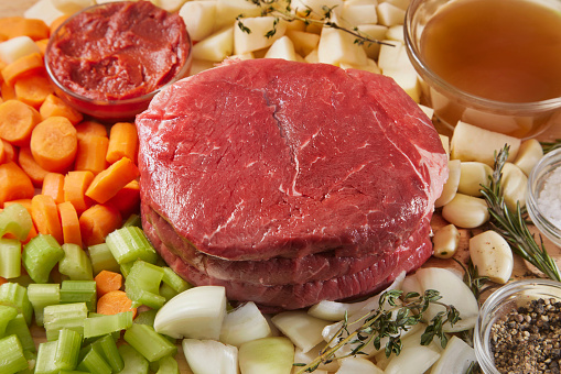 Raw Ingredients for Beef Pot Roast with: Carrots, Potatoes, Celery, Onion, garlic, Rosemary, Thyme, Beef Brown, Salt and Pepper