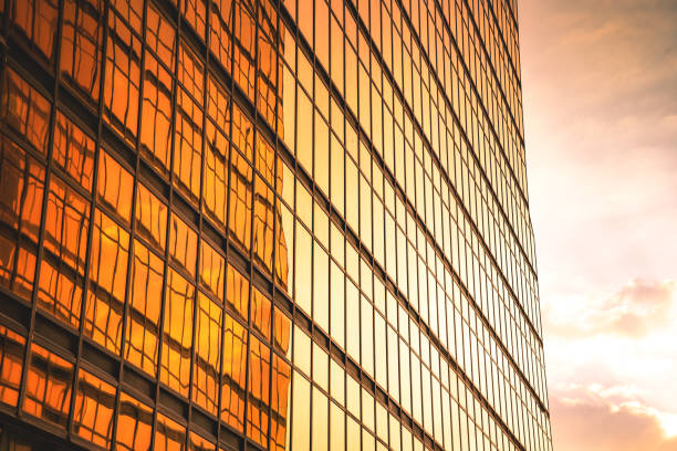 istock Looking up a reflections on glass covered corporate building 1348548225