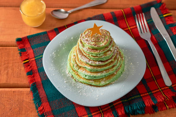 istock Christmas tree shaped pancakes on the table. Christmas breakfast concept 1348552511