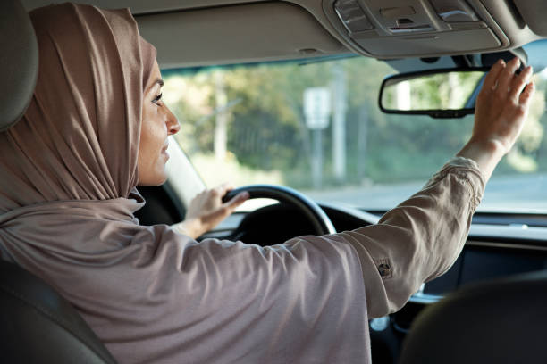 istock Young female in hijab touching mirror in front of her 1348556982