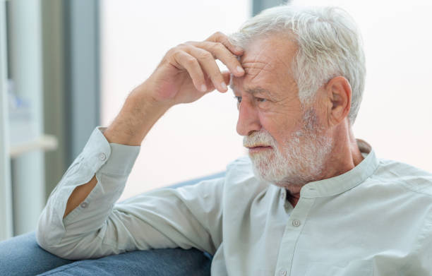 istock Thinking senior man sit on couch in living room, man thinks and sit on the sofa 1348559253