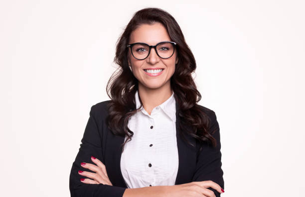 Confident business lady in eyeglasses smiling at camera Happy successful adult businesswoman in formal outfit and stylish glasses smiling and looking at camera while standing with arms crossed against white background 35 39 years stock pictures, royalty-free photos & images