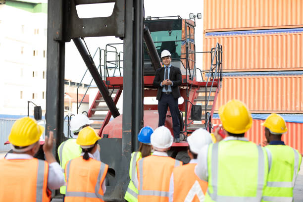 istock warehouse boss engineer standing on crane car with factory workers clapping hands for congratulations in containers warehouse storage 1348561456