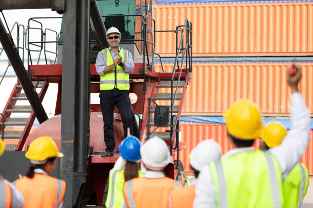 istock warehouse boss engineer standing on crane car with factory workers clapping hands for congratulations work in containers warehouse storage 1348561497