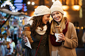 Happy people having fun together at a festive christmas fair. Christmas holiday people concept