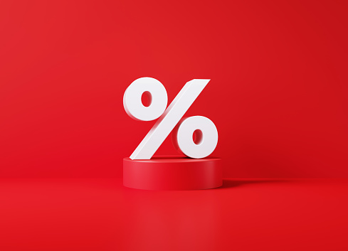 White percentage sign sitting on red podium before red background. Horizontal composition with copy space.