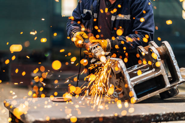 Metal worker using a grinder stock photo