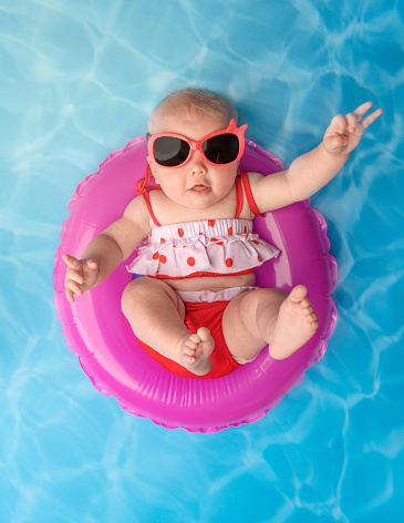 A baby girl in a pool ready for summer.