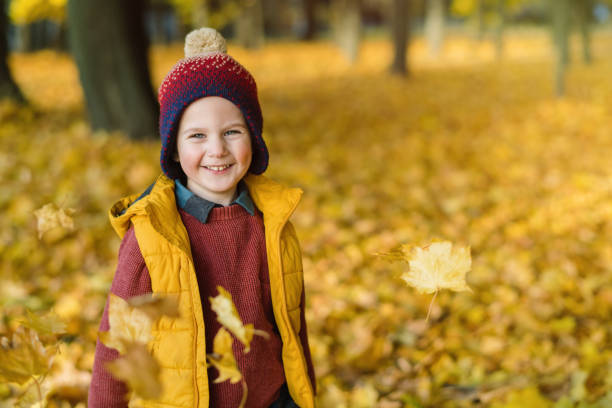 istock Little boy enjoying sunny autumn days in a park 1348574224