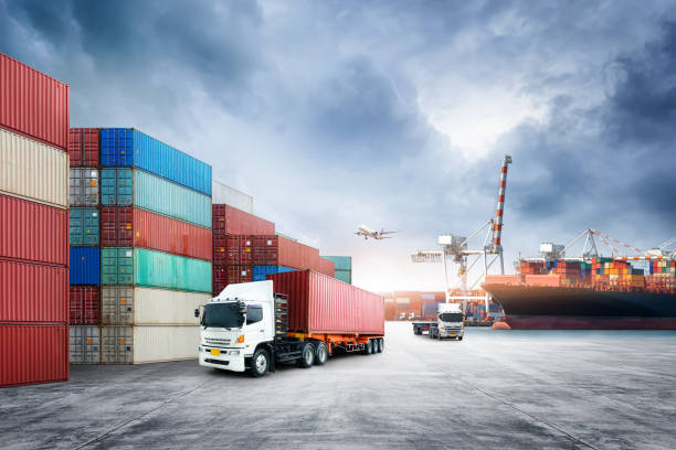 istock Business logistics and transportation concept of containers cargo freight ship and cargo plane in shipyard at dramatic blue sky, logistic import export and transport industry background 1348576119