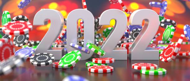 istock 2022 New Year celebration and poker chips falling on casino table. 3d illustration 1348595721