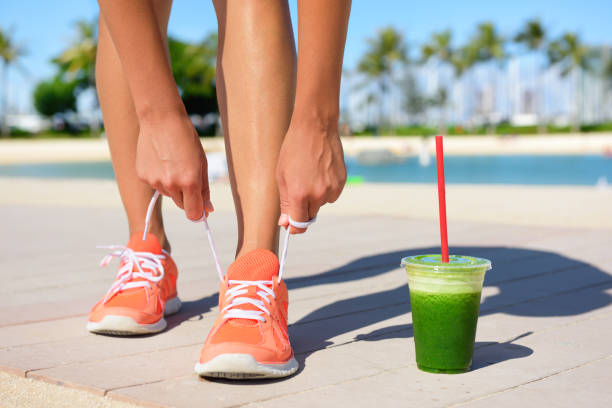 istock Running woman runner with green vegetable smoothie 1348601723