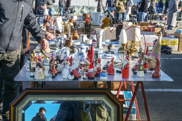 Lubeck, Germany, October 24, 2021: flea market stall with Christmas decorations, tableware and household goods on a sunny day, selected focus, narrow depth of field