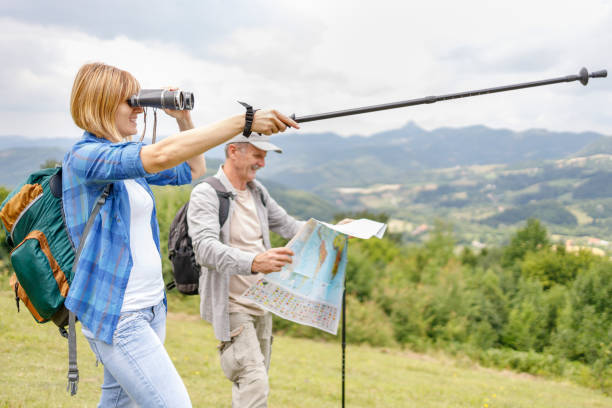 istock Woman showing direction after looking through binoculars 1348608291
