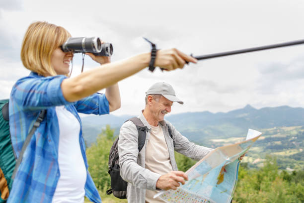 istock Woman showing direction after looking through binoculars 1348608368