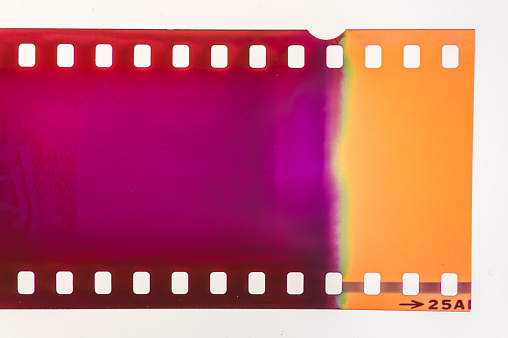 Close-up of 35mm negative photographic film, showing an abstract pattern caused by a light leak.