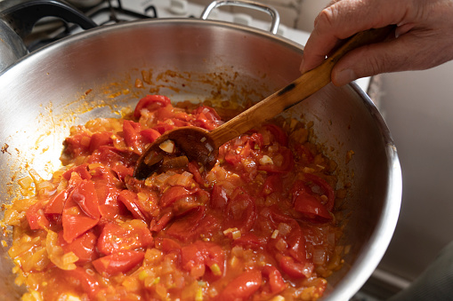 Preparing fresh tomato sauce in a domestic kitchen