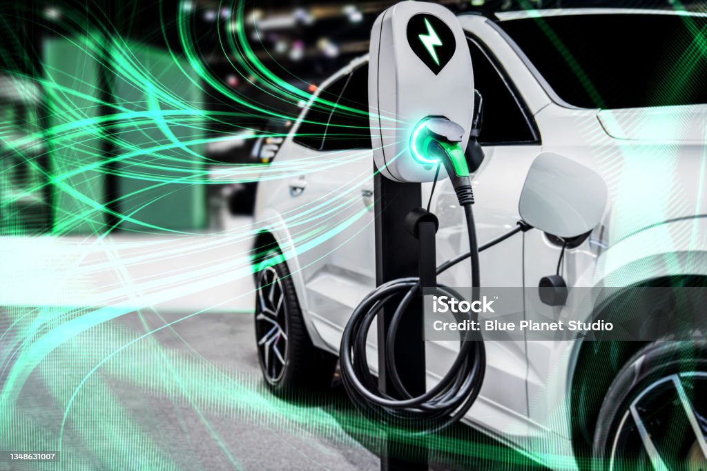 EV charging station for electric car in concept of green energy and eco power EV charging station for electric car in concept of green energy and eco power produced from sustainable source to supply to charger station in order to reduce CO2 emission . Electric Vehicle Stock Photo