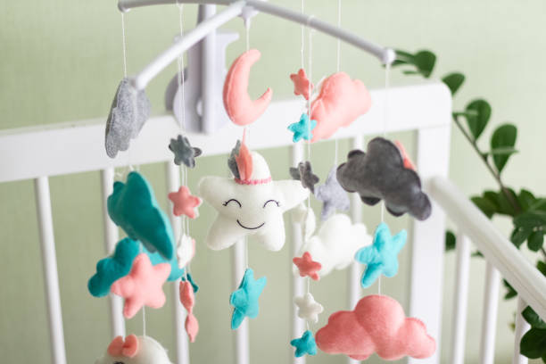 istock Textile soft toys rotate over the baby's crib. mobile for the cradle. 1348640192