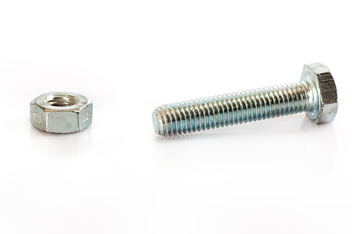 Bolt - fastener, nut, screw on white background. Horizontal photo.